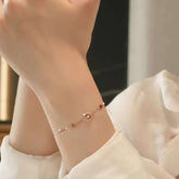 Minimalist moon-and-stars gold bracelet styled on wrist
